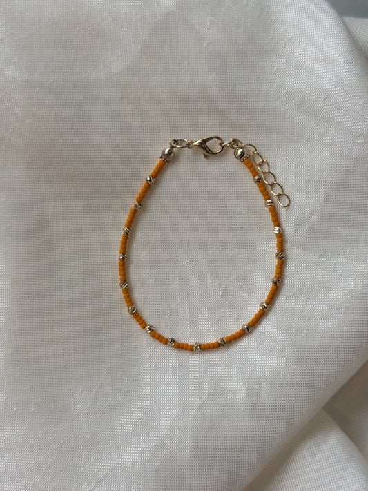 Perlenarmband mit orangen und goldfarbenen Mini-Perlen